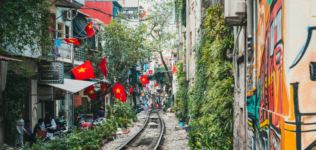 Street vendors in Vietnam selling snus and nicotine pouches next to an old railway